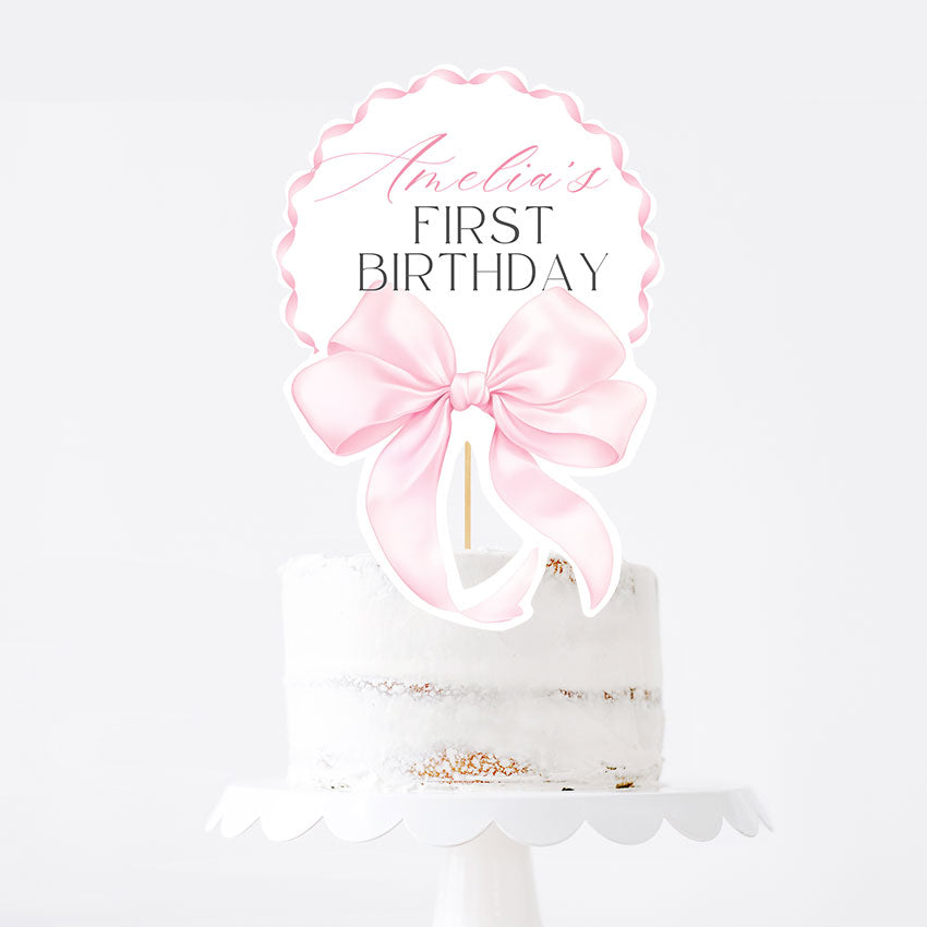 Elegant pink bow topper for a girl’s first birthday. Editable Canva template, printable and perfect for cake or centerpiece decor.
