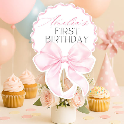 Elegant pink bow topper for a girl’s first birthday. Editable Canva template, printable and perfect for cake or centerpiece decor.