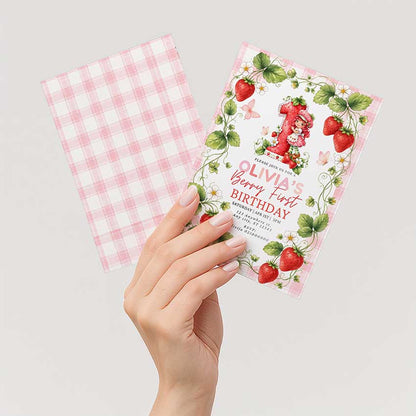 Editable strawberry birthday invitation card held in hand, berry first birthday girl Canva template